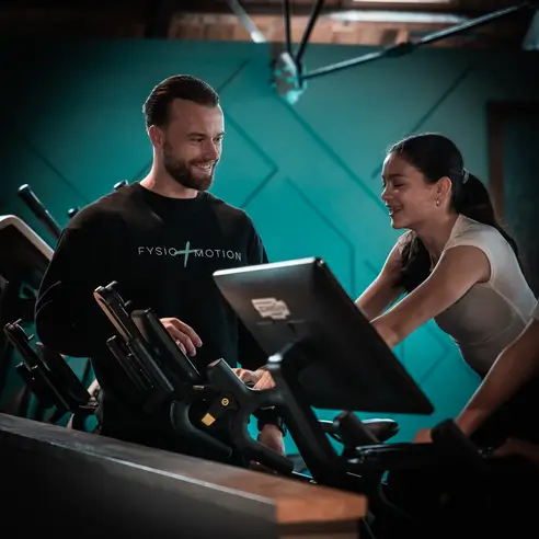 Two people exercising and smiling together.